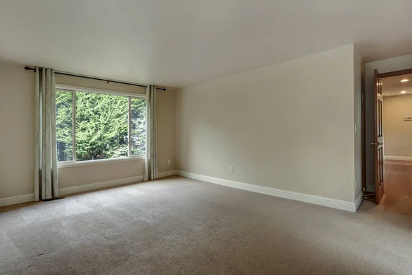 Empty bedroom of a luxury home with carpet floor.