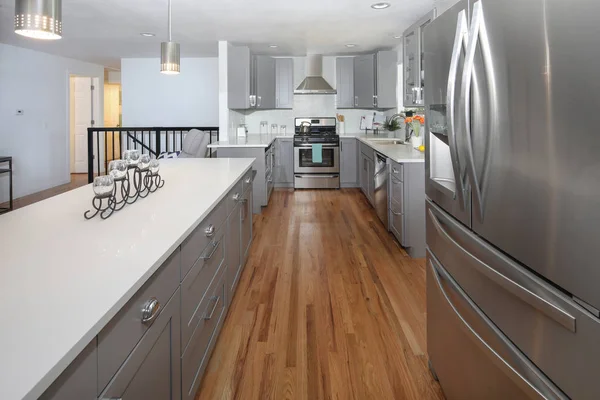 Stunning kitchen design with grey cabinets and long island.