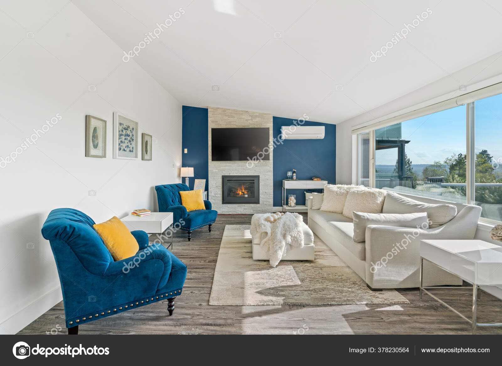 Welcoming Living Room Blue Accent Wall White Faux Fur Pillows