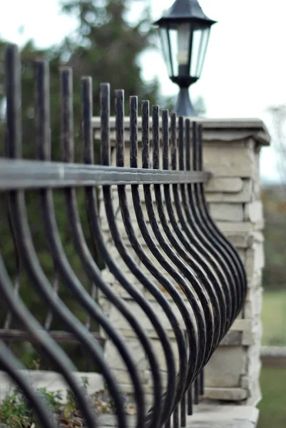 Products made of ferrous metal. Forged products on the fence.