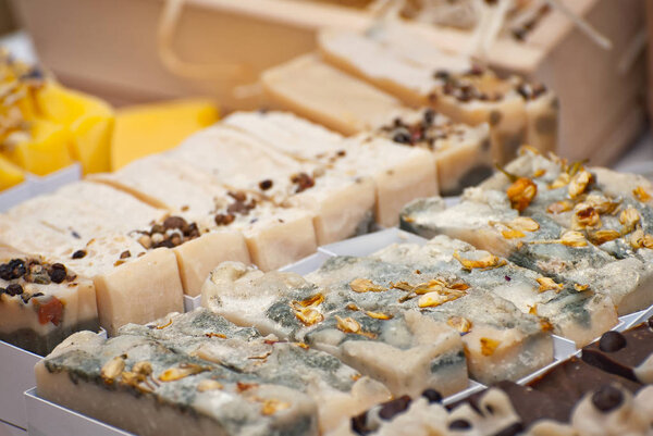 Handmade soap pieces on the table. Natural soap is sold at the fair.