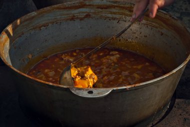 Yemekler ateşte büyük bir tencerede pişirilir. Festivalde tarla mutfağı.