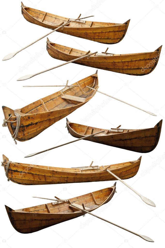Wooden replica of a viking boat. Reconstruction of historic ships and boats. Wooden ship isolated on a white background. Medieval fishing boat with oars in different angles.