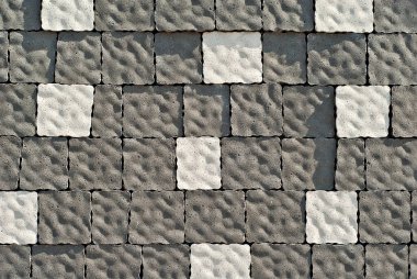 Cobblestone texture. The sidewalk tile is evenly folded. Gray cobblestones close up. clipart