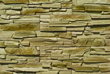 Tuğla duvar ve beton bloklar. Sıraya dizilmiş taş levha örnekleri.