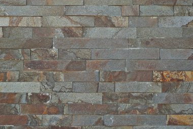 Tuğla duvar ve beton bloklar. Sıraya dizilmiş taş levha örnekleri.