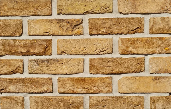 Texture of brick wall. new brickwork. Samples of wall or fence are presented at exhibitions. Yellow brick close up.