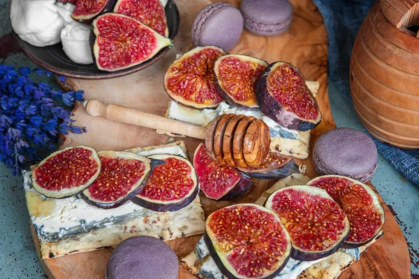 Toasts of cheese, figs and honey on whole-grain crispy bread. Close up. Selective focus.