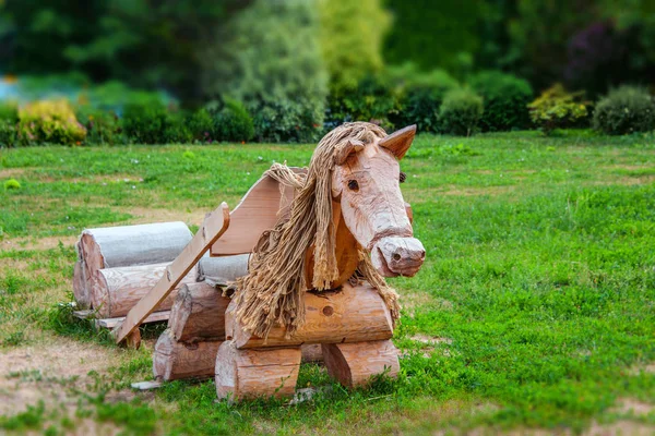Wooden horse landscape design. Lovingly decorated the area with plants and flowers.