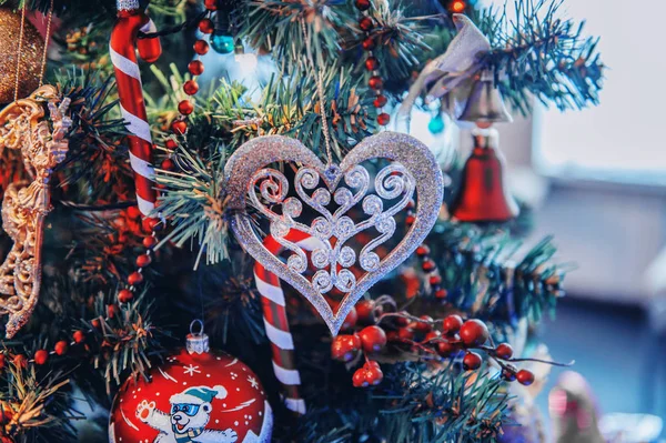 Beautiful Christmas jewelry lies on a table in a white wooden box. Decoration of the house by Christmas.