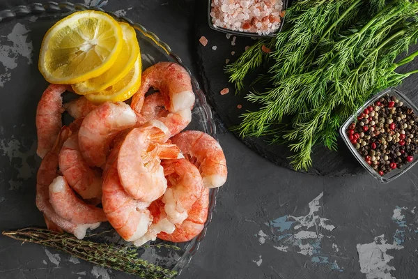 Frozen shrimp are prepared for cooking. Shrimp with spices savory lemon colored pepper dill and sea salt. Food preparation.