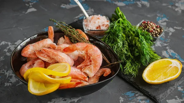 Frozen shrimp are prepared for cooking. Shrimp with spices savory lemon colored pepper dill and sea salt. Food preparation.