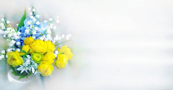 bouquet of wild white, yellow and blue flowers on a light background. Copy of the space.