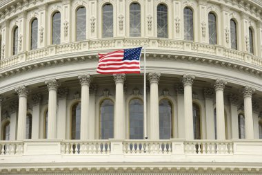 US flag on the dome of United States Capitol Building clipart