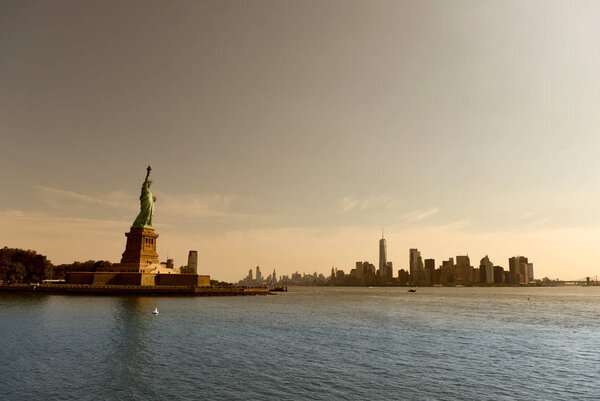 Statue of Liberty and financial district in lower Manhattan, New York City, NY, USA.