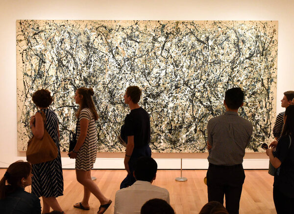 New York, USA - May 25, 2018: A visitors looks at the Jackson Pollock painting in Museum of Modern Art in New York City.