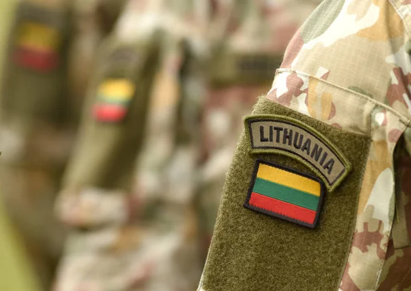 Lithuania patch flag on soldiers arm. Lithuanian military uniform. Lithuania troops