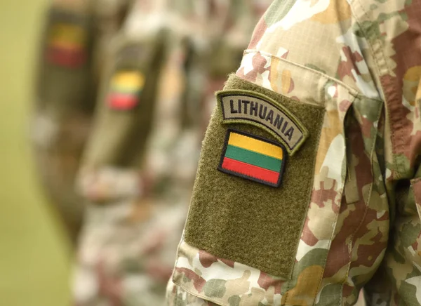 Lithuania patch flag on soldiers arm. Lithuanian military uniform. Lithuania troops