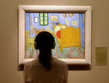 Chicago, USA - June 06, 2018: Woman look at the The Bedroom by Vincent van Gogh painting in Art Institute of Chicago. clipart