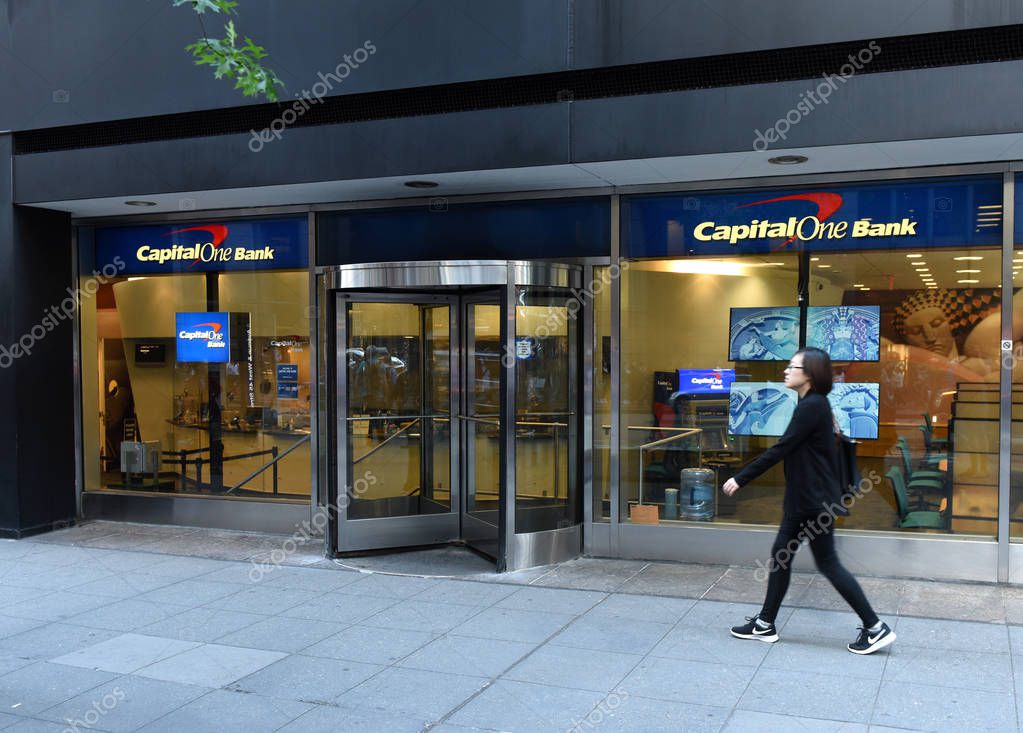 New York, USA - May 30, 2018: Woman pass near Capital One Bank in New York.