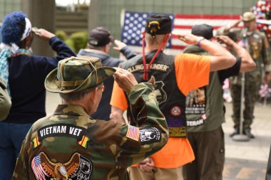New York, USA - May 28, 2018: Vietnam Veterans  salutes during meeting on Memory Day on New York Vietnam Veterans Memorial. clipart