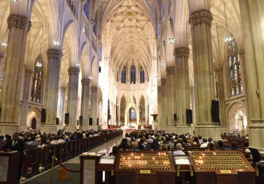 New York, USA - June 9, 2018: People on the Mass in St. Patrick's Cathedral in New York City. clipart