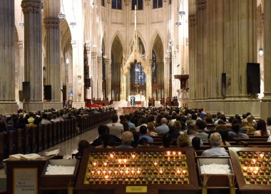 New York, USA - June 9, 2018: People on the Mass in St. Patrick's Cathedral in New York City. clipart