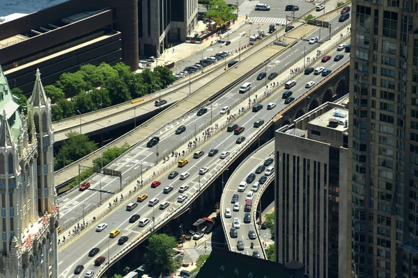 View from skyscrapers on the streets of New York City. Top view on the street with cars on the road