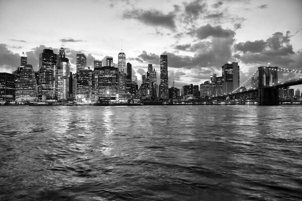 New York cityscape at night. New York City, financial district in lower Manhattan view from Brooklyn Bridge Park.