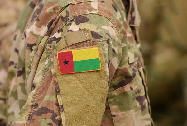 Guinea-Bissau flag on soldiers arm. Guinea-Bissau troops (collage)