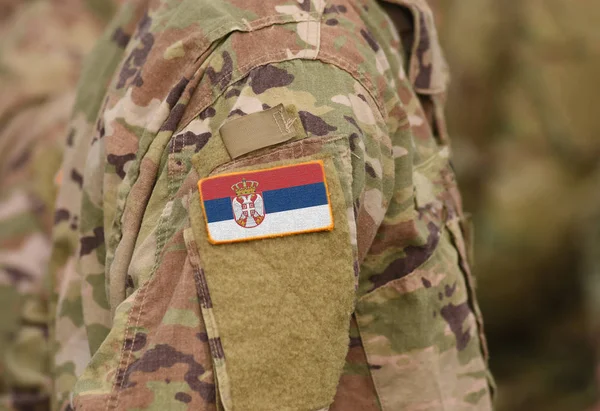Flag of Serbia on soldiers arm (collage).