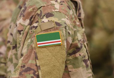 Çeçen Cumhuriyeti İçkerya bayrağı üzerinde askeri üniformalar. Çeçen Cumhuriyeti İçkerya bayrağı askerler kolundaki. (kolaj).