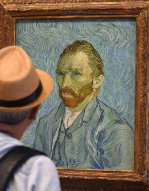  Visitor near the Self-Portrait by Vincent van Gogh painting in Museum d'Orsay in Paris, France. clipart