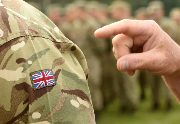 UK flag on soldiers arm. UK military uniform.