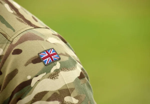 UK flag on soldiers arm. UK military uniform.