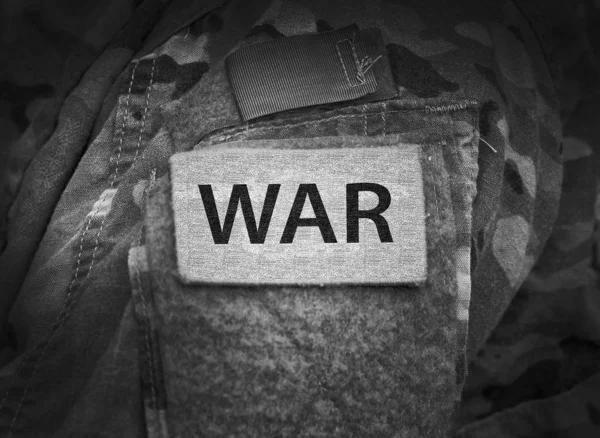 Inscription WAR on military uniform. War concept. — Stock Photo, Image