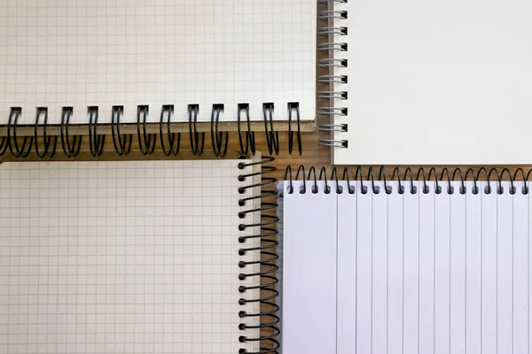 Open notepads set isolated on wooden backdrop