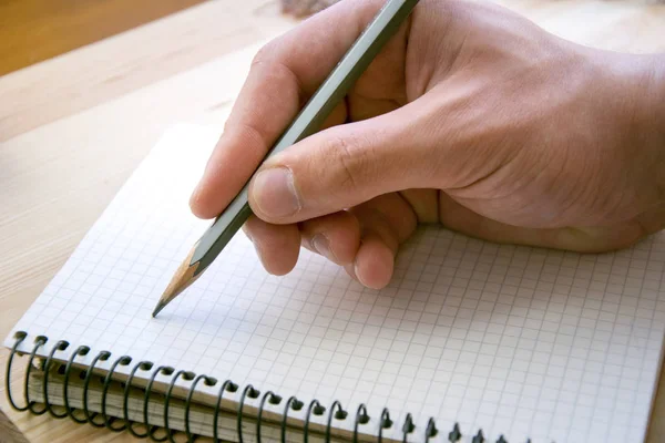 Human writing something in personal paper notebook — Stock Photo, Image