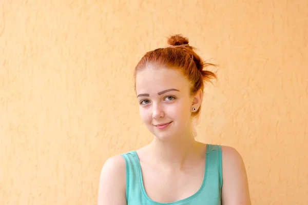 Close up shoot of young pretty lady without make-up with red hair tied in bun — Stock Photo, Image