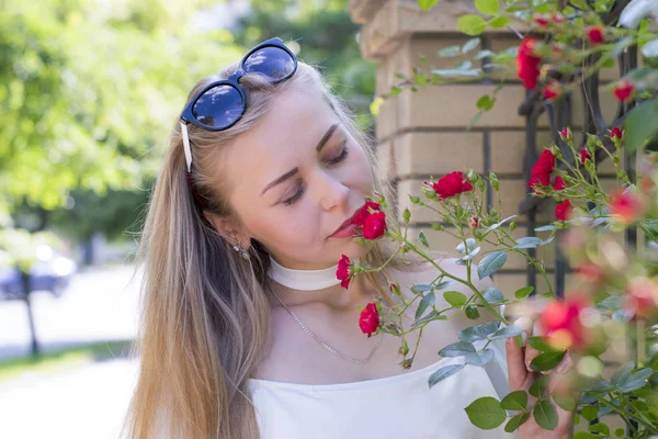 Cute engaging girl with beautiful flowers — Stock Photo, Image