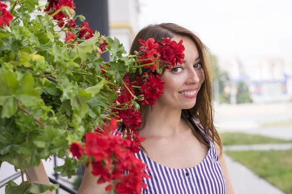 Charming smiling girl with flowers — Stock Photo, Image