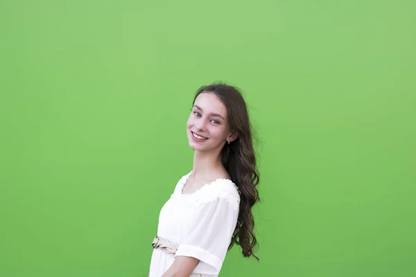 Young charming woman on green wall — Stock Photo, Image