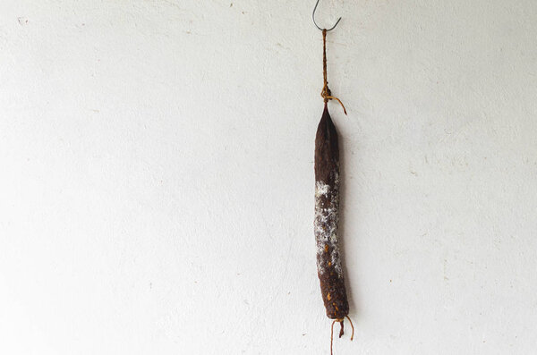 Sausage hunging on rope on white background