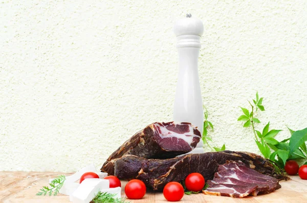 Dried meat and mill on wooden board with tomatoes and cheese — Stock Image Dried Meat Mill Wooden Board Tomatoes Cheese Stock Picture