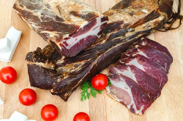 Delicious dried meat on wooden table with red tomatoes and delicious cheese — Stock Image Delicious Dried Meat Wooden Table Red Tomatoes Delicious Cheese Royalty Free Stock Photos