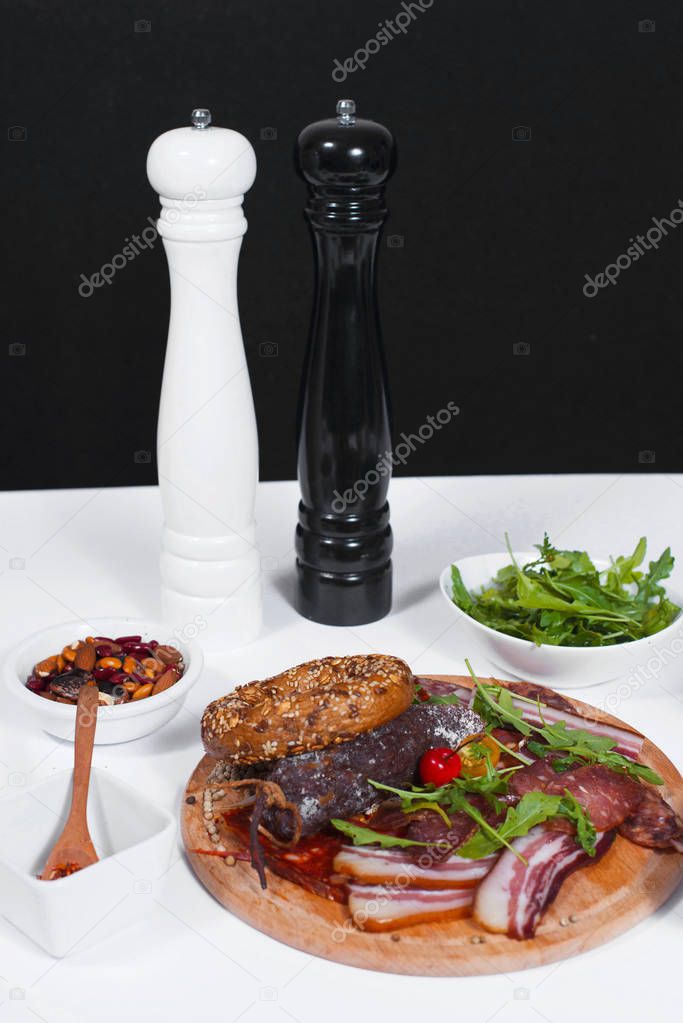 Front view of colorful plate full with food, and black and white pepper mill.