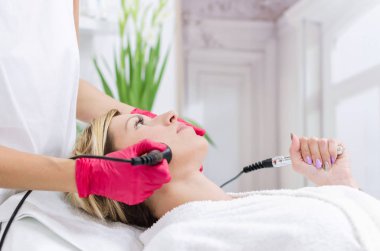 Donanım kozmetik. Yordam bir güzellik salonu kaldırma Radyofrekans almak güzel genç kadın portre resim.