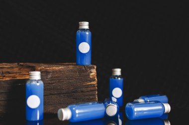 çok mavi sıvı ve siyah arka plan, tıp kavramı, kozmetik ürünleri, beyaz boşluk ile önden görünümü küçük dolu cam tüp