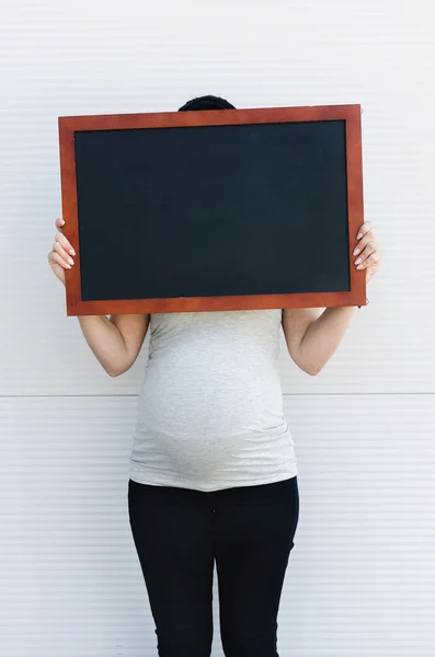 Vista Frontal Mujer Embarazada Con Una Pizarra Con Espacio Para — Foto de Stock