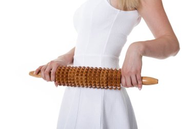 Cropped image of young beautiful woman holding anticellulite massage rolling pin. clipart